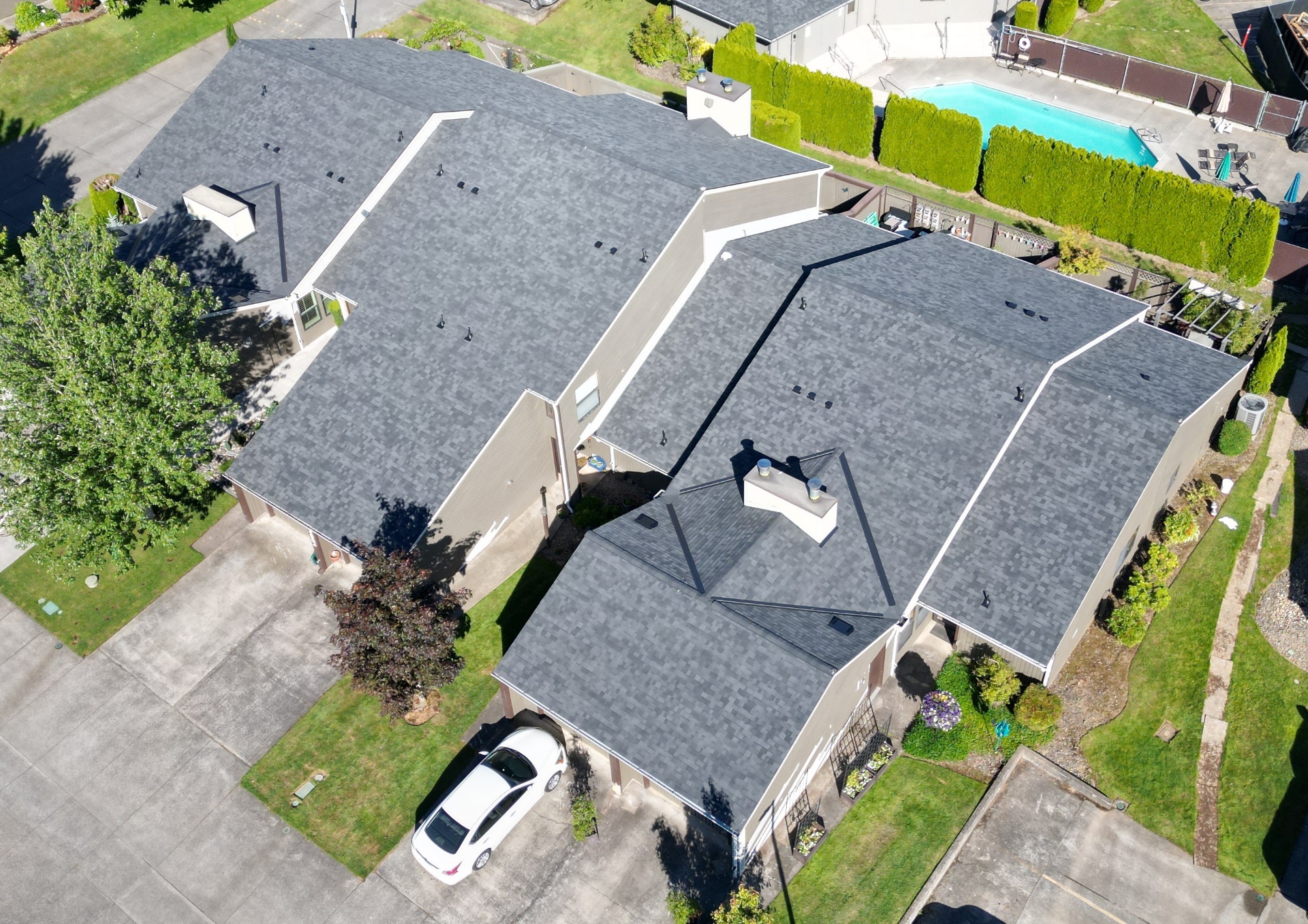 Aerial view of a finished gray shingle roof on a residential home
