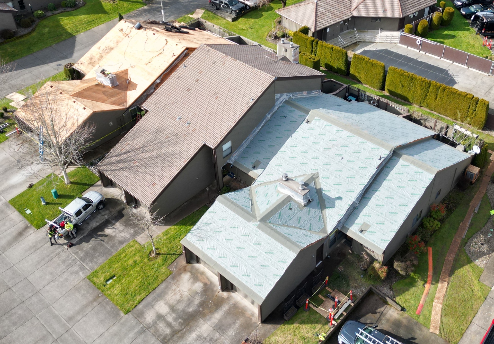 Aerial view showing roof replacement in progress with tear-off and underlayment installed