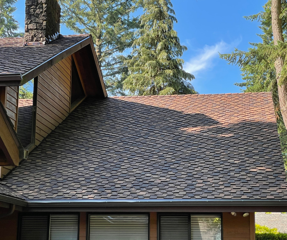 Close-up view of a finished shingle roof with cedar-tone color blending